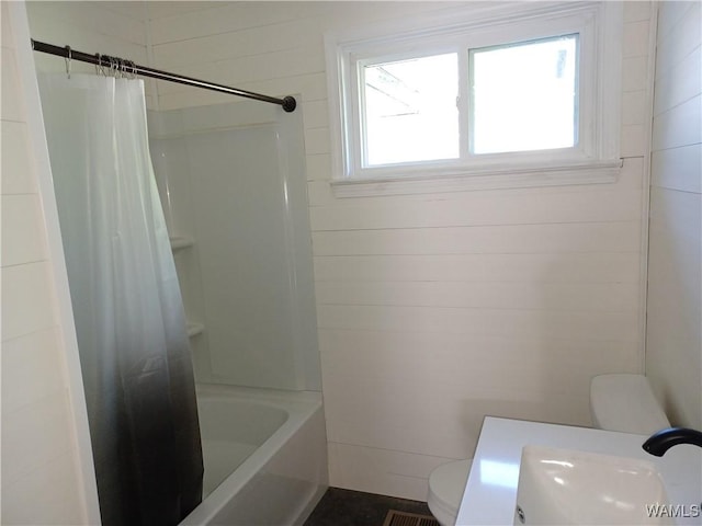 2205 18th Ave, Northport, AL 35476 - bathroom featuring toilet, a sink, and shower / tub combo with curtain