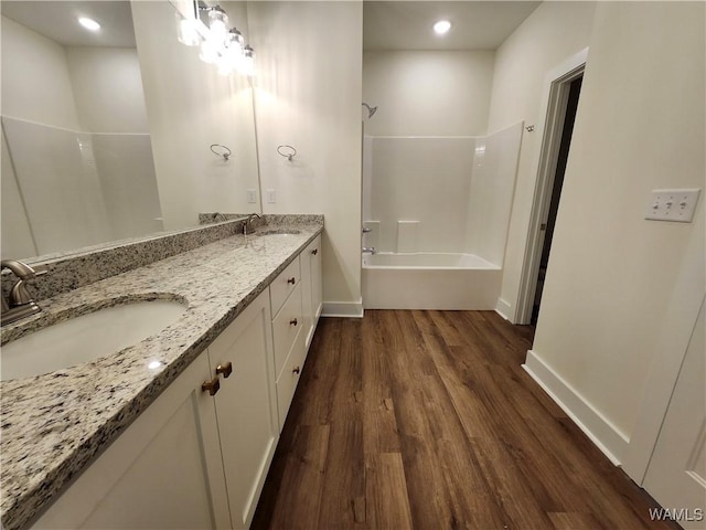195 Lecroy Cir, Brent, AL 35034 - full bath with wood finished floors, shower / bathtub combination, baseboards, and double vanity
