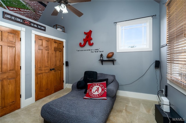 sitting room with light carpet, ceiling fan, and a healthy amount of sunlight