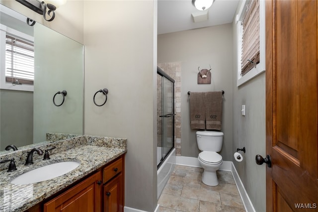 full bathroom featuring toilet, vanity, and combined bath / shower with glass door