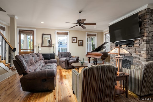 living room featuring hardwood / wood-style flooring, ceiling fan, and ornamental molding