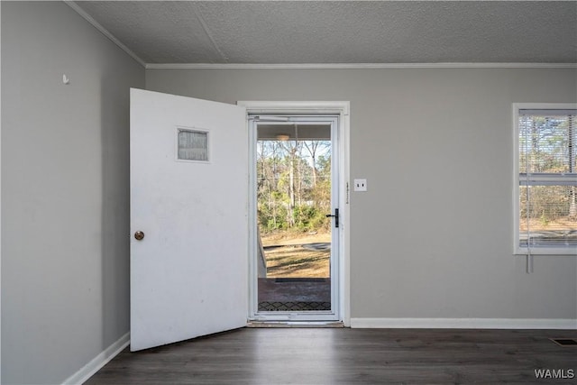 entryway with baseboards, a textured ceiling, ornamental molding, and wood finished floors