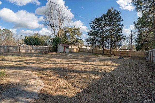 view of yard with a storage shed, a fenced backyard, and an outdoor structure