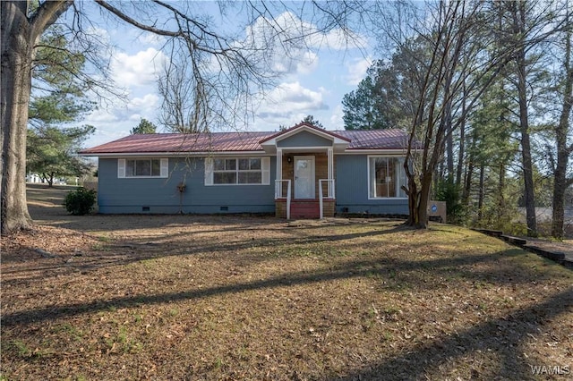 view of front of house with a front yard, crawl space, and metal roof