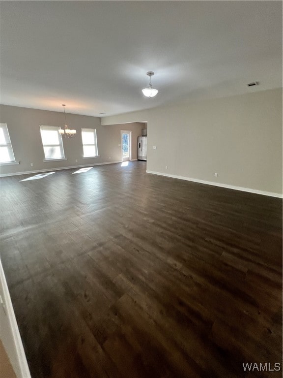 interior space featuring a chandelier and dark hardwood / wood-style flooring