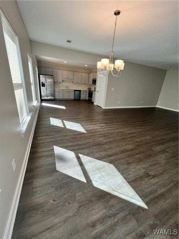 interior space featuring a chandelier and dark hardwood / wood-style floors