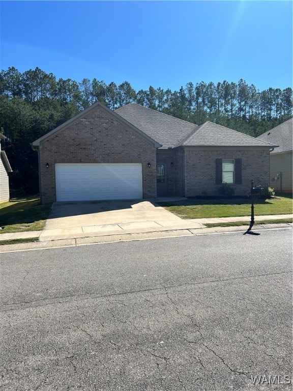 single story home featuring a front yard and a garage