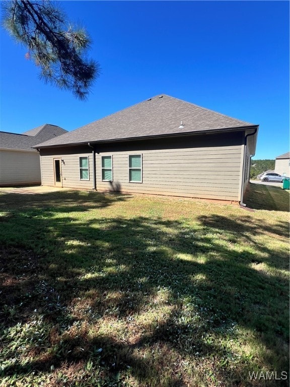 view of property exterior featuring a lawn