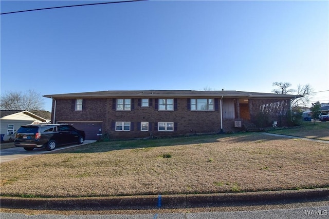 view of front of house with a garage and a front lawn