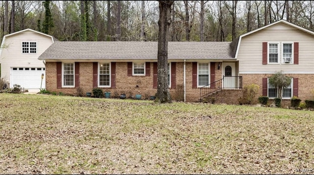 806 Arrowhead Vlg, Winfield, AL 35594 - tri-level home featuring a shingled roof, brick siding, and a front yard