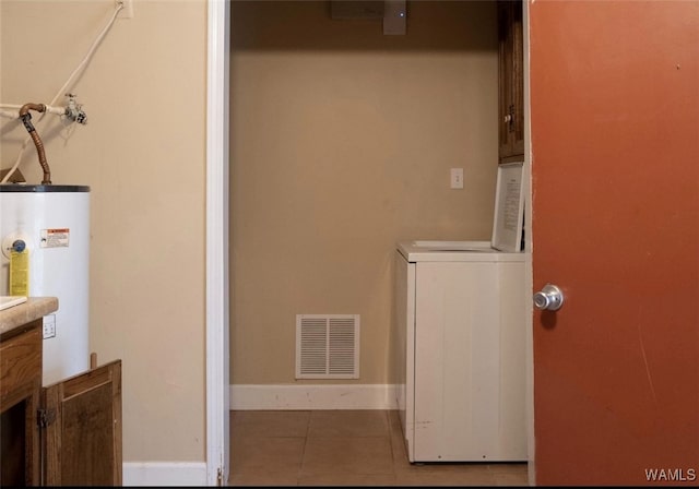 806 Arrowhead Vlg, Winfield, AL 35594 - clothes washing area with washer / clothes dryer, cabinet space, water heater, visible vents, and tile patterned floors