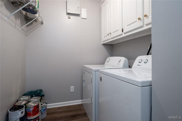 laundry room featuring cabinet space, baseboards, dark wood-type flooring, and washer and dryer