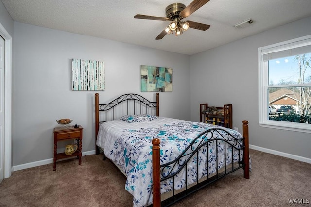 bedroom featuring carpet, visible vents, a ceiling fan, a textured ceiling, and baseboards