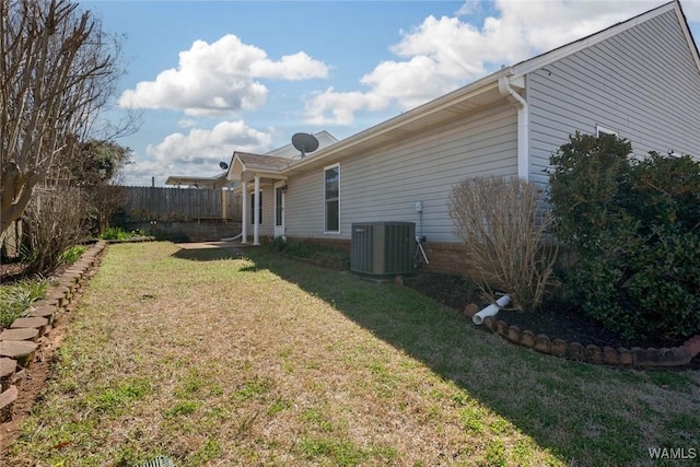 view of yard featuring fence and central air condition unit