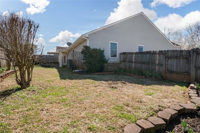 view of side of property with a fenced backyard, central AC unit, and a lawn