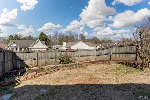 view of yard with a fenced backyard and a residential view