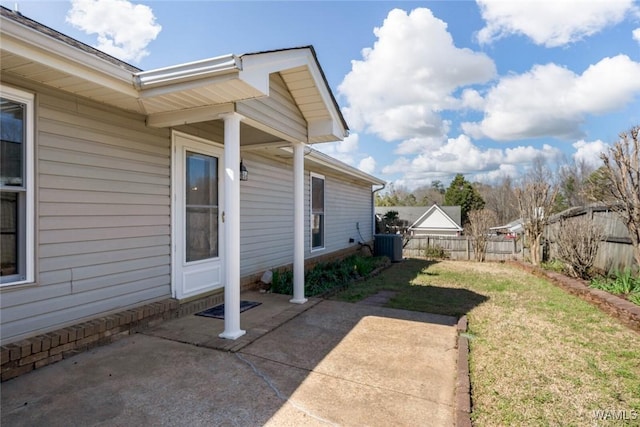 view of yard featuring central AC, fence, and a patio