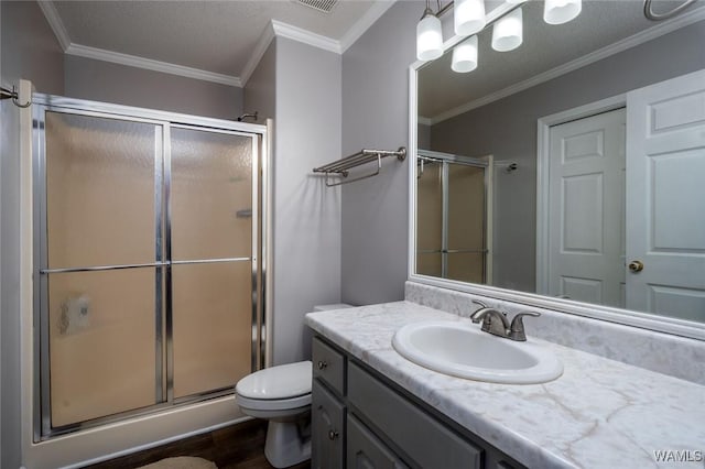 full bathroom with crown molding, a shower stall, toilet, and vanity