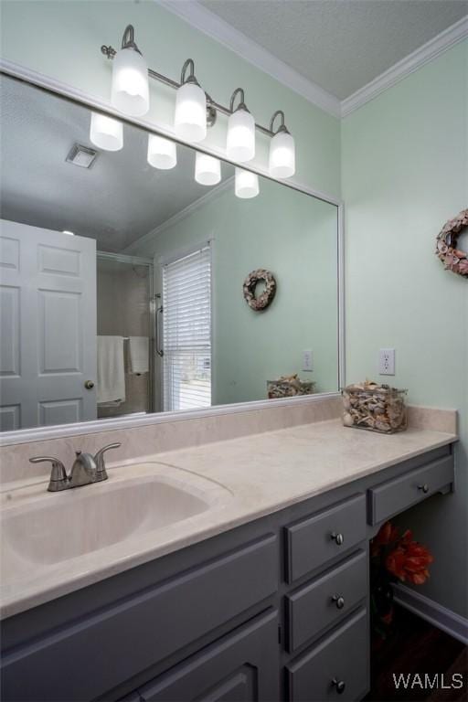 bathroom with a shower with curtain, visible vents, crown molding, and vanity