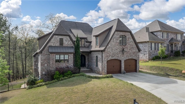 view of front facade featuring a front yard, a garage, brick siding, concrete driveway, and fence