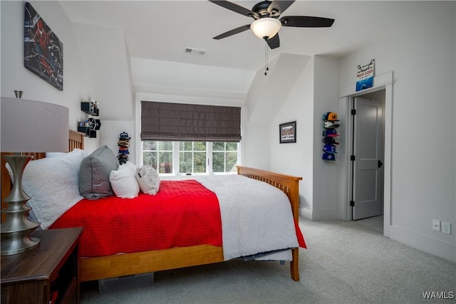 carpeted bedroom with baseboards, visible vents, ceiling fan, and vaulted ceiling