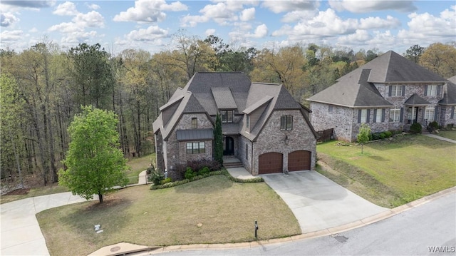 view of front of home featuring a garage, a front yard, driveway, and stone siding