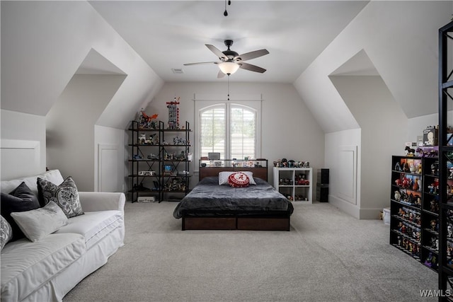 carpeted bedroom with ceiling fan and vaulted ceiling