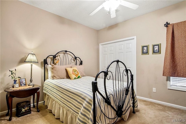 bedroom with a closet, light colored carpet, and ceiling fan