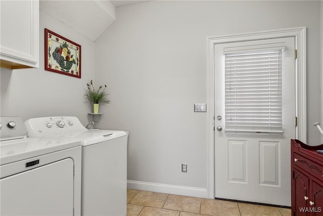 laundry area with light tile patterned flooring, cabinets, and washing machine and dryer