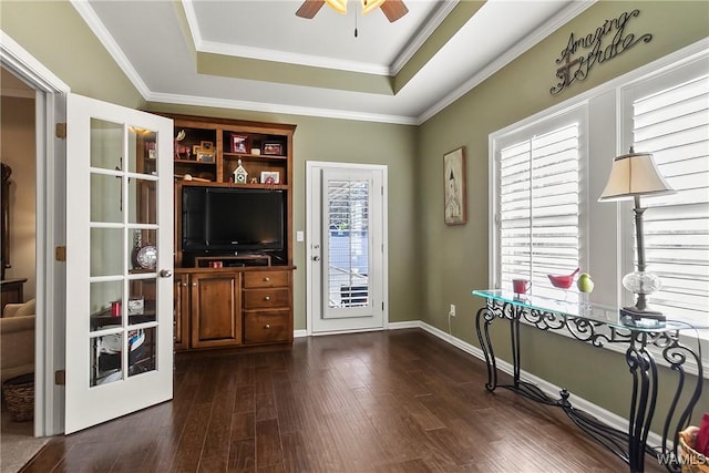 office area featuring crown molding, a tray ceiling, dark hardwood / wood-style flooring, and ceiling fan