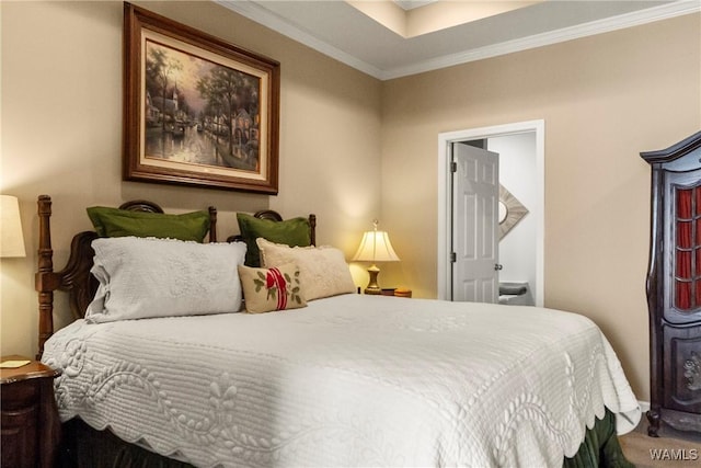 bedroom featuring ornamental molding and ensuite bathroom