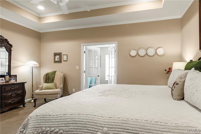 carpeted bedroom featuring a tray ceiling, ceiling fan, and crown molding