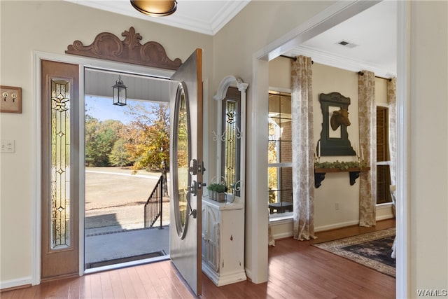 foyer with hardwood / wood-style floors and ornamental molding