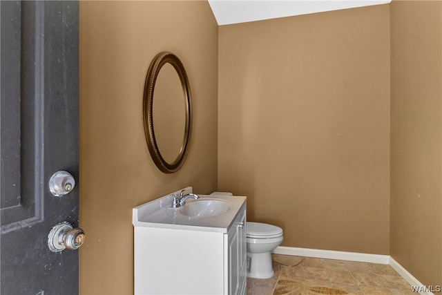 bathroom featuring tile patterned floors, vanity, and toilet