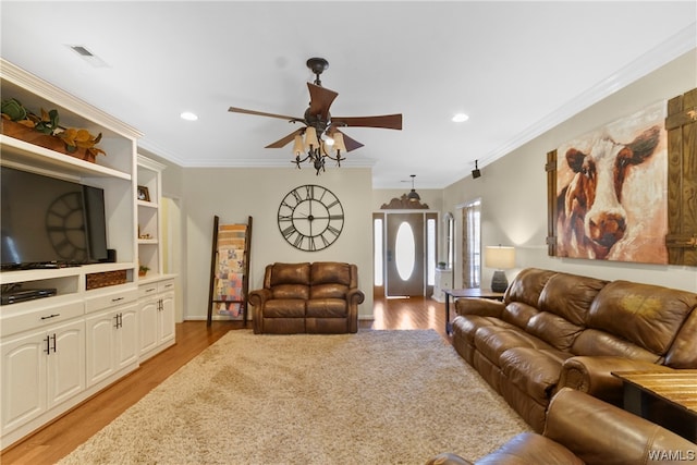 living room featuring light hardwood / wood-style floors, ceiling fan, and ornamental molding