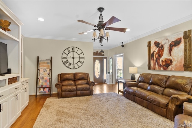 living room with ceiling fan, light hardwood / wood-style floors, and ornamental molding