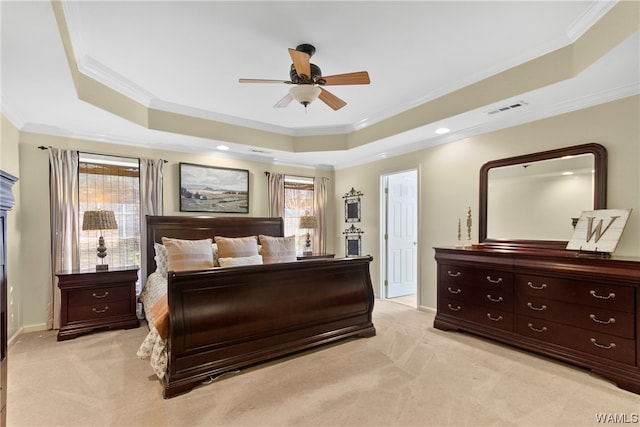 bedroom featuring a tray ceiling, crown molding, and ceiling fan