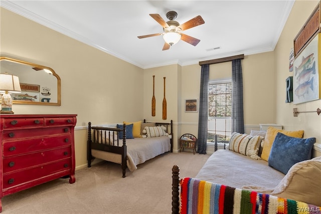 carpeted bedroom featuring ceiling fan and crown molding