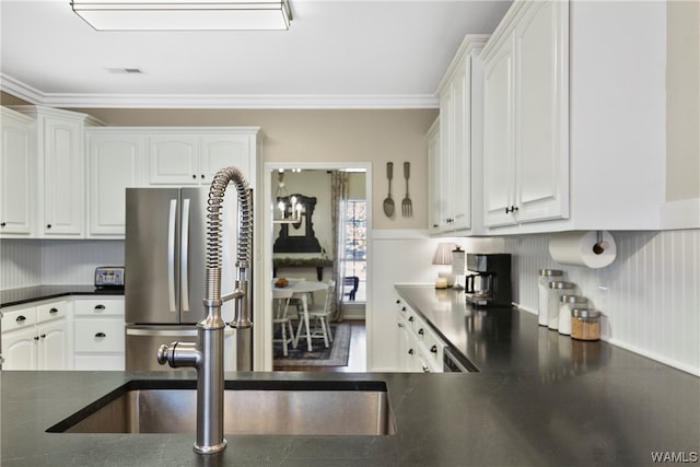 kitchen with hardwood / wood-style flooring, white cabinetry, crown molding, and sink