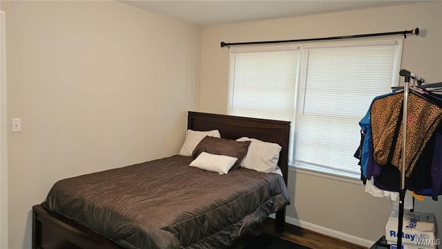 bedroom with dark wood-type flooring