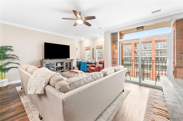 living room with hardwood / wood-style flooring, ceiling fan, and ornamental molding