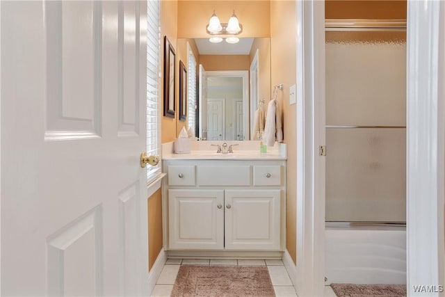 bathroom with tile patterned flooring, a shower with door, vanity, and an inviting chandelier