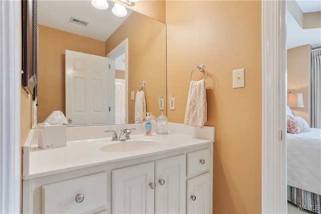 bathroom with vanity, visible vents, and ensuite bathroom