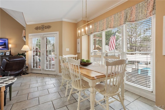 dining room with crown molding and an inviting chandelier