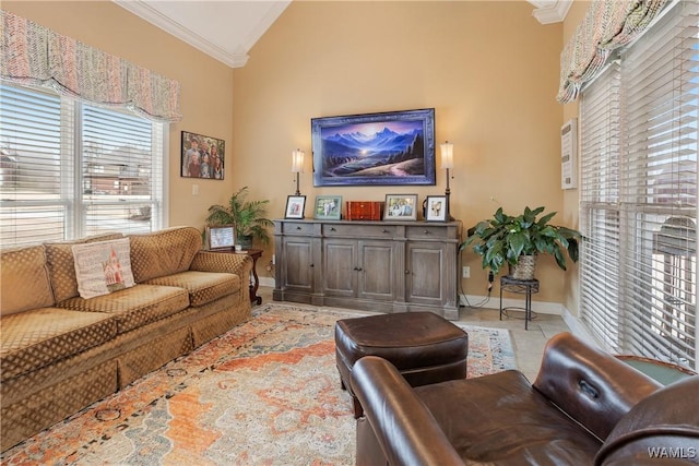 living area with baseboards, high vaulted ceiling, crown molding, and light tile patterned flooring