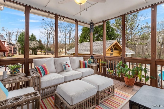 sunroom / solarium featuring plenty of natural light and ceiling fan