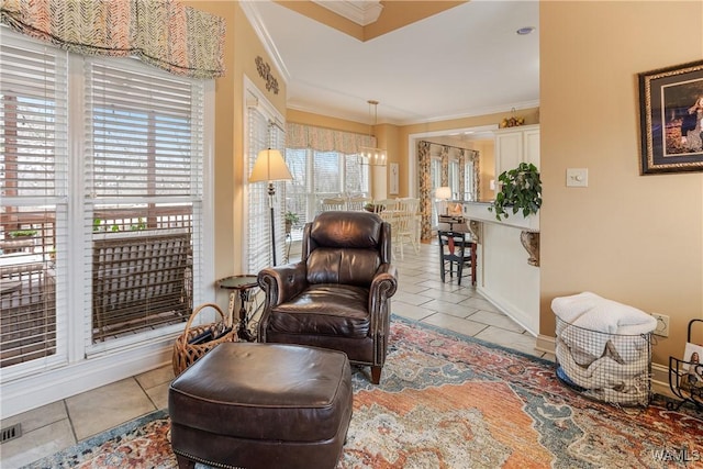 living area featuring ornamental molding, light tile patterned flooring, visible vents, and baseboards