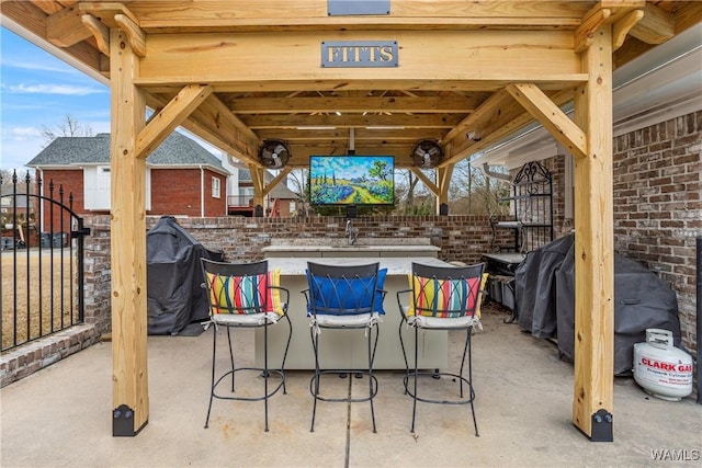 view of patio / terrace featuring a bar and a grill