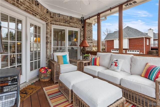 sunroom / solarium featuring ceiling fan