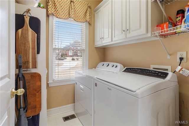 laundry room with a healthy amount of sunlight, cabinet space, baseboards, and independent washer and dryer